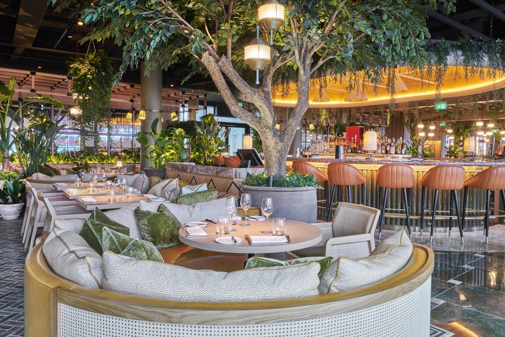 14 Stories, Fenchurch Street: curved banquette beneath an indoor tree