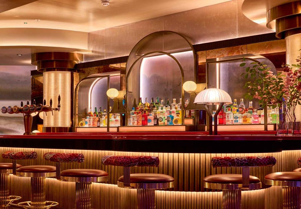 1878 at 3Arena: lit back bar with arched mirror and velvet stools