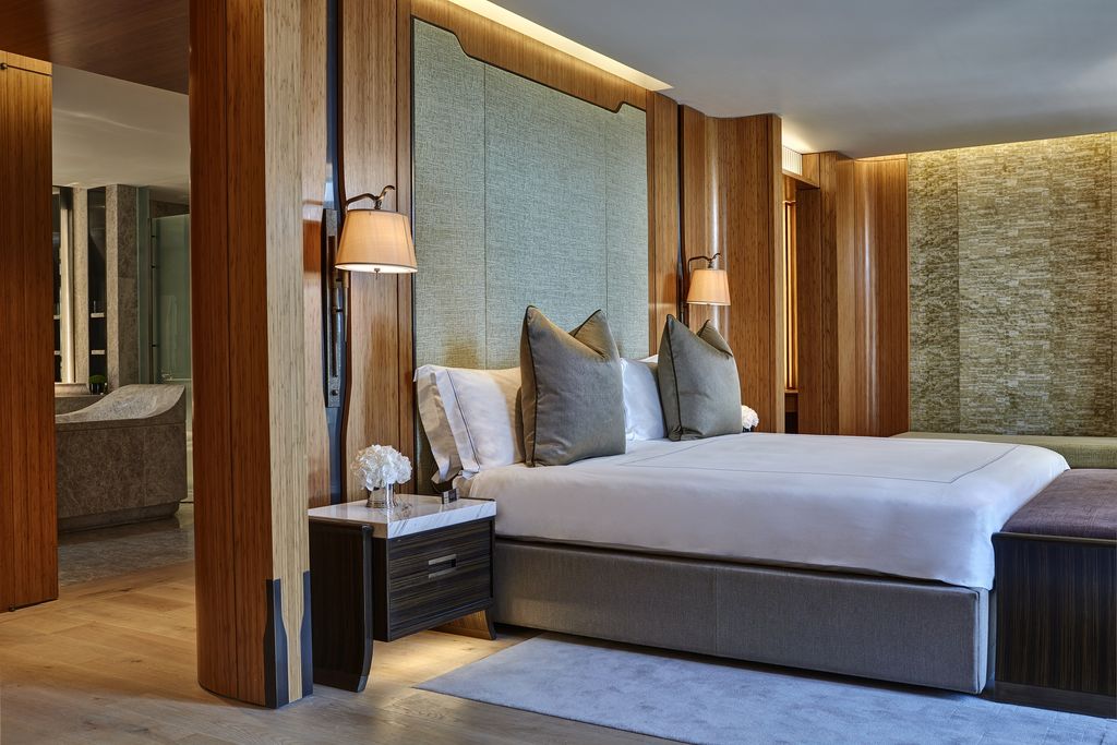 Walnut-panelled bed wall in a guest suite at The Berkeley