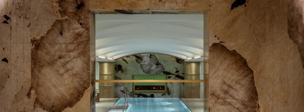 Corinthia Brussels lap pool framed by marble-effect walls