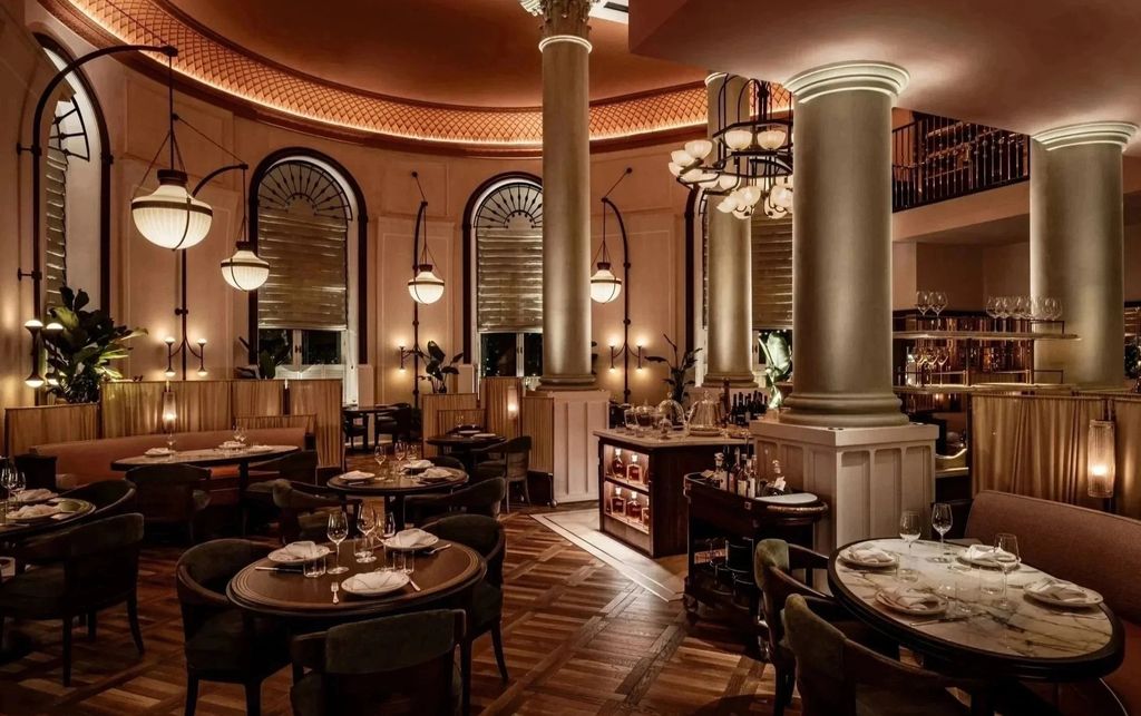 Corinthia London restaurant with marble columns, arched windows and herringbone timber floor