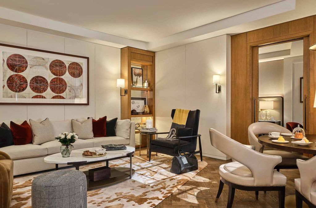 Corinthia London suite living room with walnut panelling and bespoke shelving