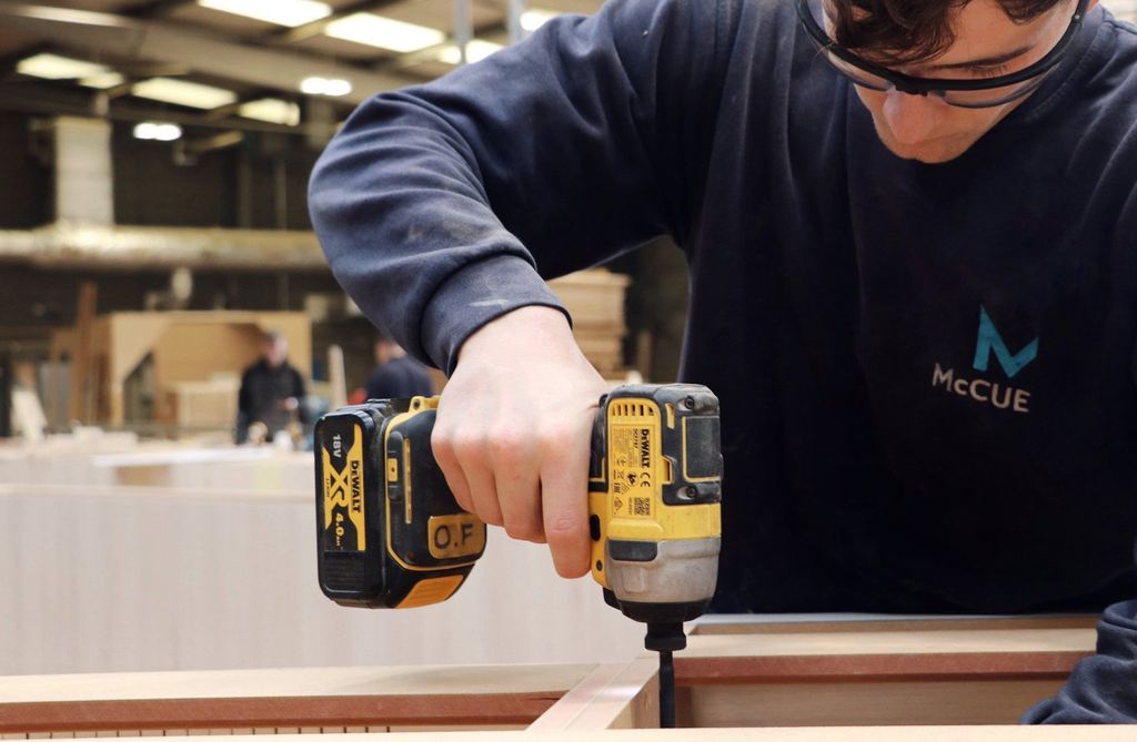 A McCue joiner drilling a timber unit in the Carrickfergus workshop