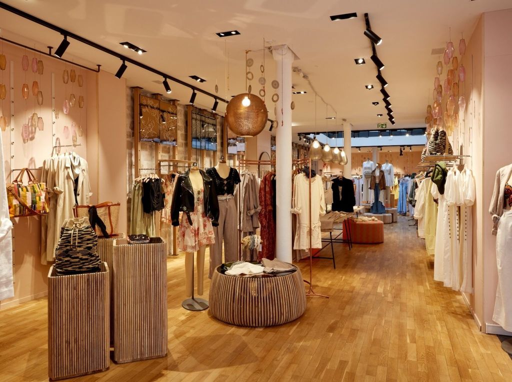 Free People store with timber flooring, woven pendants and boho displays