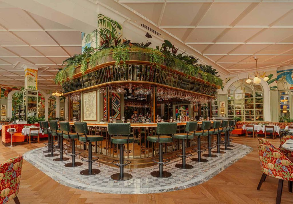The Ivy Belfast planted island bar beneath arched windows