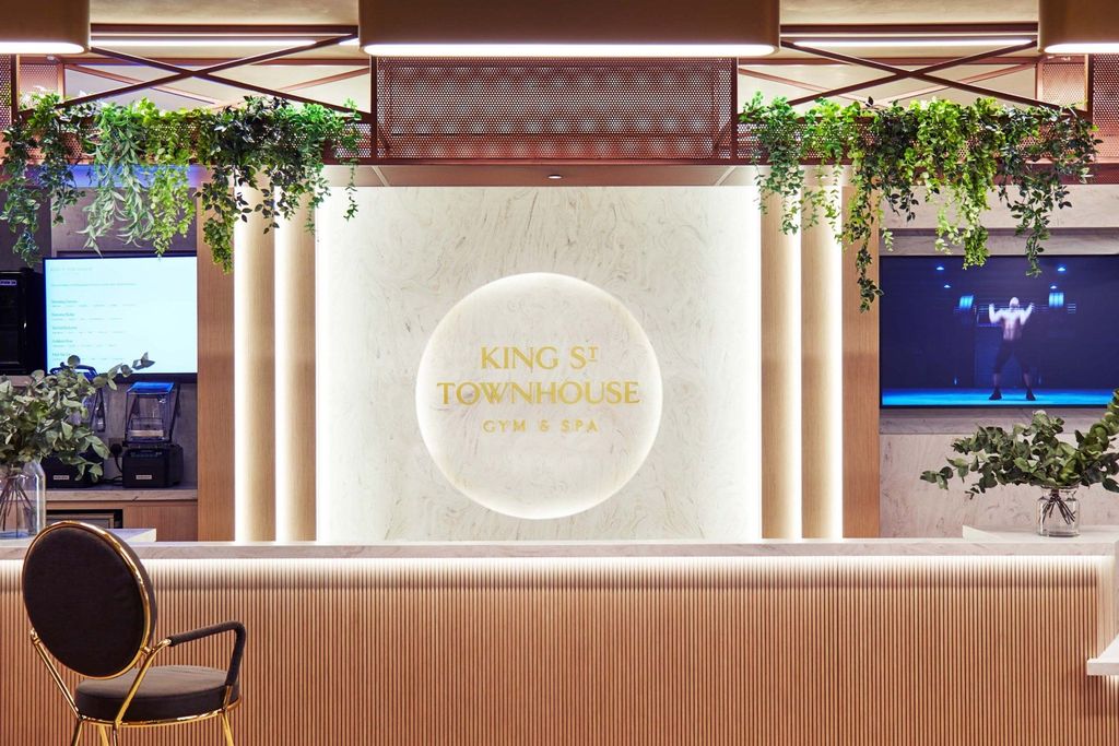 King Street Townhouse reception desk with backlit logo on stone