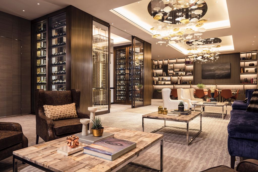 Lillie Square residents’ lounge with wine walls, library joinery and glass chandelier