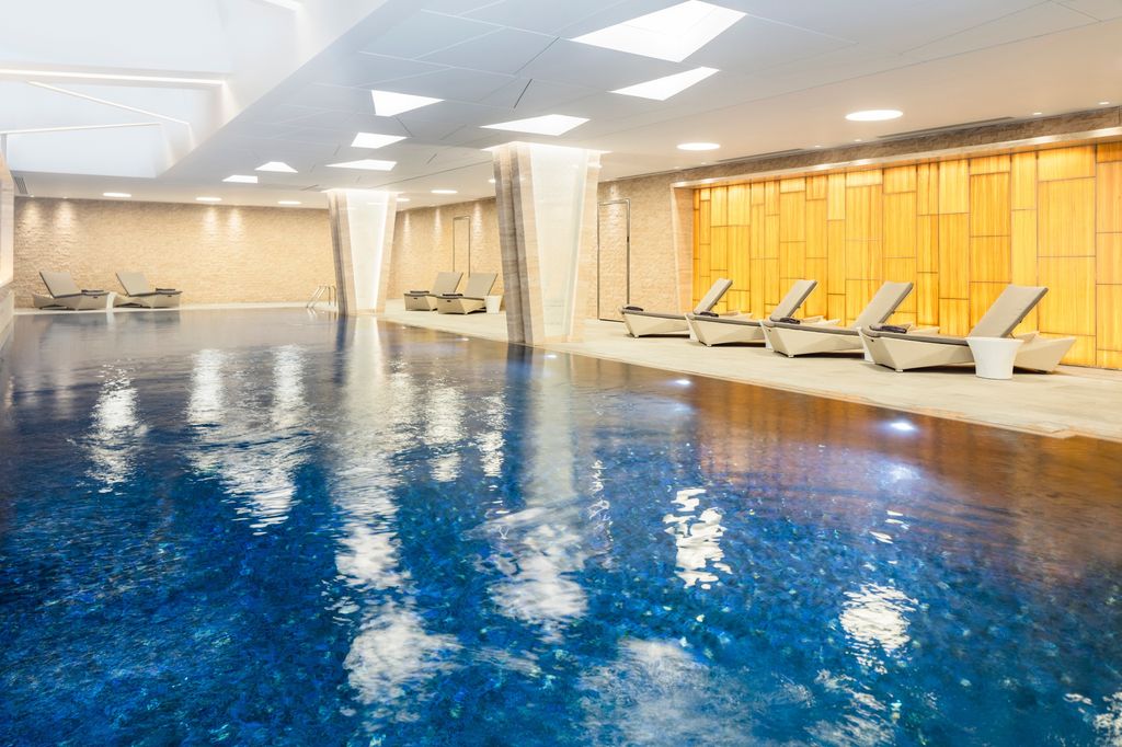 Lillie Square pool with backlit onyx wall and loungers