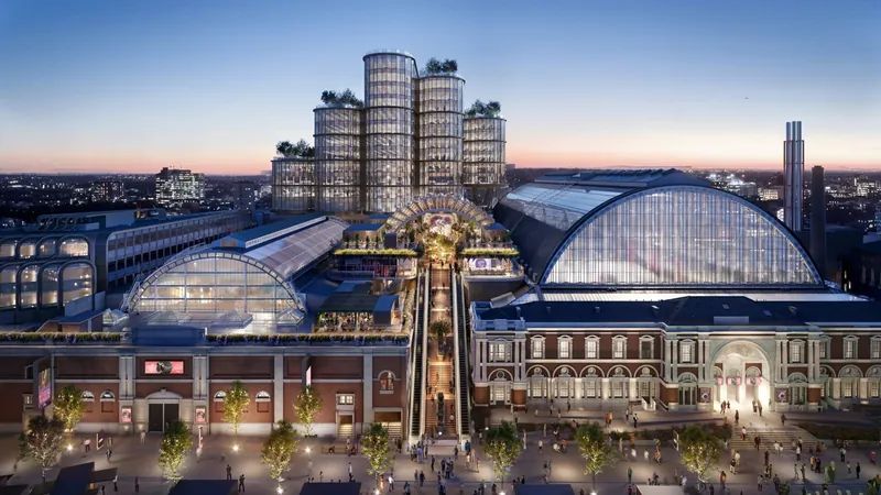 Visual of the transformed Olympia London at dusk, with its glazed halls, rooftop terraces and new towers