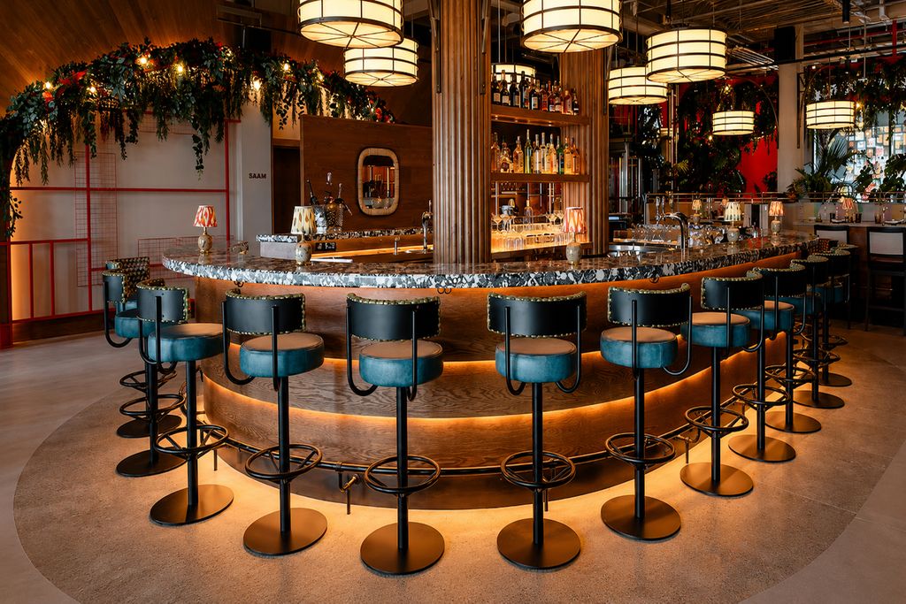 Curved island bar with blue stools at Elemente, Hamburg