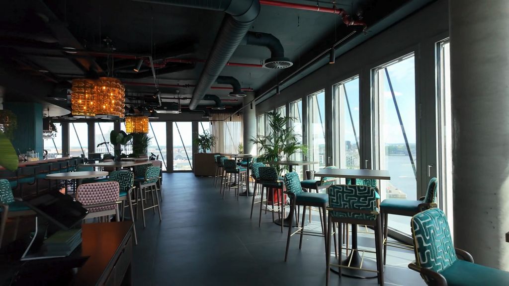 Elemente, Hamburg: high-level bar seating in teal velvet beside floor-to-ceiling harbour views