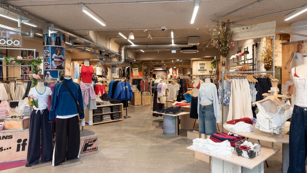 Open Urban Outfitters sales floor with rails and display tables