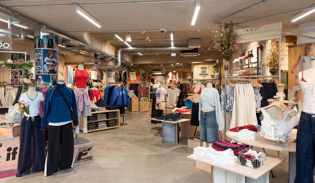 Urban Outfitters store interior with timber fixtures and layered displays