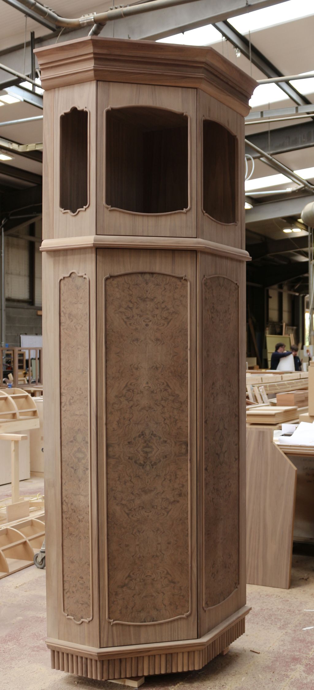 Octagonal walnut cabinet with burr walnut panels and carved cornice, finished in the McCue joinery workshop