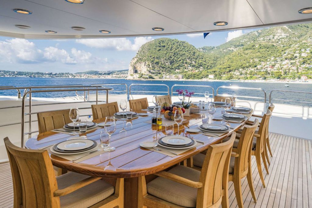 Superyacht aft-deck dining table with Mediterranean view